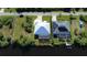 Aerial view of two canal-front homes with solar panels at 13654 Allamanda Cir, Port Charlotte, FL 33981