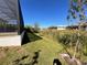 Landscaped backyard with grassy area and canal view at 13654 Allamanda Cir, Port Charlotte, FL 33981