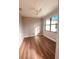 Simple bedroom with light walls, wood flooring, and a ceiling fan at 13654 Allamanda Cir, Port Charlotte, FL 33981