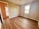 Bedroom with wood flooring and access to the backyard at 13654 Allamanda Cir, Port Charlotte, FL 33981