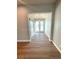 Inviting foyer with light hardwood floors and modern light fixture, complemented by natural light at 13654 Allamanda Cir, Port Charlotte, FL 33981