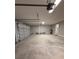 Spacious garage with one garage door open, overhead lighting and neutral paint at 13654 Allamanda Cir, Port Charlotte, FL 33981