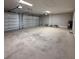 Spacious garage with two garage doors, overhead lighting and neutral paint at 13654 Allamanda Cir, Port Charlotte, FL 33981