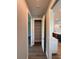 Hallway with an open pantry, wood flooring, and leads to the kitchen at 13654 Allamanda Cir, Port Charlotte, FL 33981