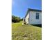 Side view of a modern, single-story house with a grassy lawn at 13654 Allamanda Cir, Port Charlotte, FL 33981