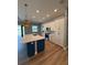 Modern kitchen island featuring a dishwasher, open shelving, and stunning pendant lighting at 13654 Allamanda Cir, Port Charlotte, FL 33981