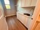 Laundry room with white cabinets, quartz countertop, and a utility sink at 13654 Allamanda Cir, Port Charlotte, FL 33981