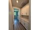Laundry room with white cabinetry, countertop, and door to another room at 13654 Allamanda Cir, Port Charlotte, FL 33981