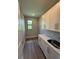 Bright laundry room boasts ample storage with white cabinets and quartz countertops at 13654 Allamanda Cir, Port Charlotte, FL 33981