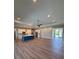 Expansive living area features hardwood floors, recessed lighting, and a stylish blue kitchen island at 13654 Allamanda Cir, Port Charlotte, FL 33981