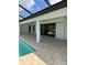 Inviting outdoor area with a sparkling pool, a spacious patio, and sliding glass doors at 13654 Allamanda Cir, Port Charlotte, FL 33981