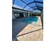 A screened-in pool with brick pavers offers a refreshing outdoor living area at 13654 Allamanda Cir, Port Charlotte, FL 33981