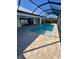 Inviting screened-in pool with paved patio and relaxing view at 13654 Allamanda Cir, Port Charlotte, FL 33981