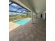 The screened-in pool area features a ceiling fan, patio and view of the neighborhood at 13654 Allamanda Cir, Port Charlotte, FL 33981