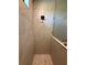Elegant shower with marble-look tiled walls, glass door, and unique pebble floor at 13654 Allamanda Cir, Port Charlotte, FL 33981