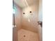 Large shower with dual shower heads, neutral tile, and a window at 13654 Allamanda Cir, Port Charlotte, FL 33981