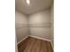 Empty walk-in closet features wood-look floors and wire shelving at 13654 Allamanda Cir, Port Charlotte, FL 33981