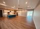 Spacious living room with light wood flooring and access to the kitchen at 13654 Allamanda Cir, Port Charlotte, FL 33981