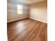 Bright bedroom with wood-look flooring and large window at 13654 Allamanda Cir, Port Charlotte, FL 33981