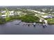 Aerial view of waterfront home with dock and nearby boats at 2033 Treasure Ln, Punta Gorda, FL 33982