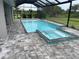 Screened-in pool with spa and brick patio offers a relaxing outdoor living space at 2033 Treasure Ln, Punta Gorda, FL 33982