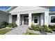 Front entrance with double doors, a walkway, and landscaping at 2033 Treasure Ln, Punta Gorda, FL 33982