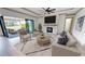 Living room with fireplace, sliding doors to patio, and stylish furniture at 2033 Treasure Ln, Punta Gorda, FL 33982