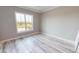 Bright bedroom with wood-look flooring and large window at 28944 Gin Ln, Punta Gorda, FL 33982