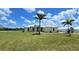Single-Gathering home with a manicured lawn and palm trees at 28944 Gin Ln, Punta Gorda, FL 33982