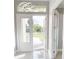 Bright entryway with double doors, a modern chandelier, and polished floors at 28944 Gin Ln, Punta Gorda, FL 33982