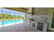 Modern outdoor kitchen with stainless steel appliances and stone countertops at 28944 Gin Ln, Punta Gorda, FL 33982