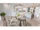 Modern kitchen with glass dining table and breakfast bar at 28944 Gin Ln, Punta Gorda, FL 33982