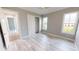 Bedroom with wood-look floors, two windows, and a closet at 28944 Gin Ln, Punta Gorda, FL 33982