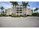Attractive three-story building with palm trees and parking at 255 West End Dr # 1412, Punta Gorda, FL 33950