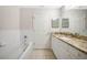Bathroom with granite countertop, white cabinets, and bathtub at 255 West End Dr # 1412, Punta Gorda, FL 33950