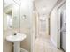 Clean bathroom with pedestal sink and hallway access to laundry at 255 West End Dr # 1412, Punta Gorda, FL 33950