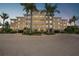 Building exterior at dusk, featuring palm trees at 255 West End Dr # 1412, Punta Gorda, FL 33950