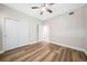 Bedroom with wood-look floors, double doors, and ceiling fan at 255 West End Dr # 1412, Punta Gorda, FL 33950
