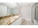 Bathroom with granite countertop, white cabinets, and shower at 255 West End Dr # 1412, Punta Gorda, FL 33950