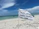 Private beach access marked with a 'Do Not Trespass' flag at 6300 Midnight Pass Rd # 20, Sarasota, FL 34242