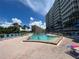 Relaxing community pool with ample lounge chairs for sunbathing at 6300 Midnight Pass Rd # 20, Sarasota, FL 34242