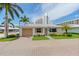 Quaint beachfront cottage with a paved driveway and landscaping at 6300 Midnight Pass Rd # 20, Sarasota, FL 34242