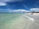 Peaceful beach scene with calm water and white sand at 6300 Midnight Pass Rd # 20, Sarasota, FL 34242