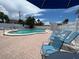 Inviting community pool with blue lounge chairs at 6300 Midnight Pass Rd # 20, Sarasota, FL 34242