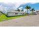White exterior home with lush landscaping and a brick-paved driveway at 6300 Midnight Pass Rd # 20, Sarasota, FL 34242