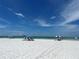 Peaceful beach scene with clear blue skies and calm waters at 6300 Midnight Pass Rd # 20, Sarasota, FL 34242