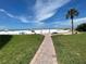 Brick pathway leads to beach with umbrellas and lounge chairs at 6300 Midnight Pass Rd # 20, Sarasota, FL 34242