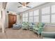 Relaxing sunroom with wicker chairs, a wooden cabinet, and plantation shutters at 6300 Midnight Pass Rd # 20, Sarasota, FL 34242