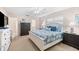 Main bedroom with king bed, dresser, and ensuite bathroom access at 6300 Midnight Pass Rd # 20, Sarasota, FL 34242