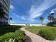 Walkway to the beach with lush landscaping at 6300 Midnight Pass Rd # 20, Sarasota, FL 34242